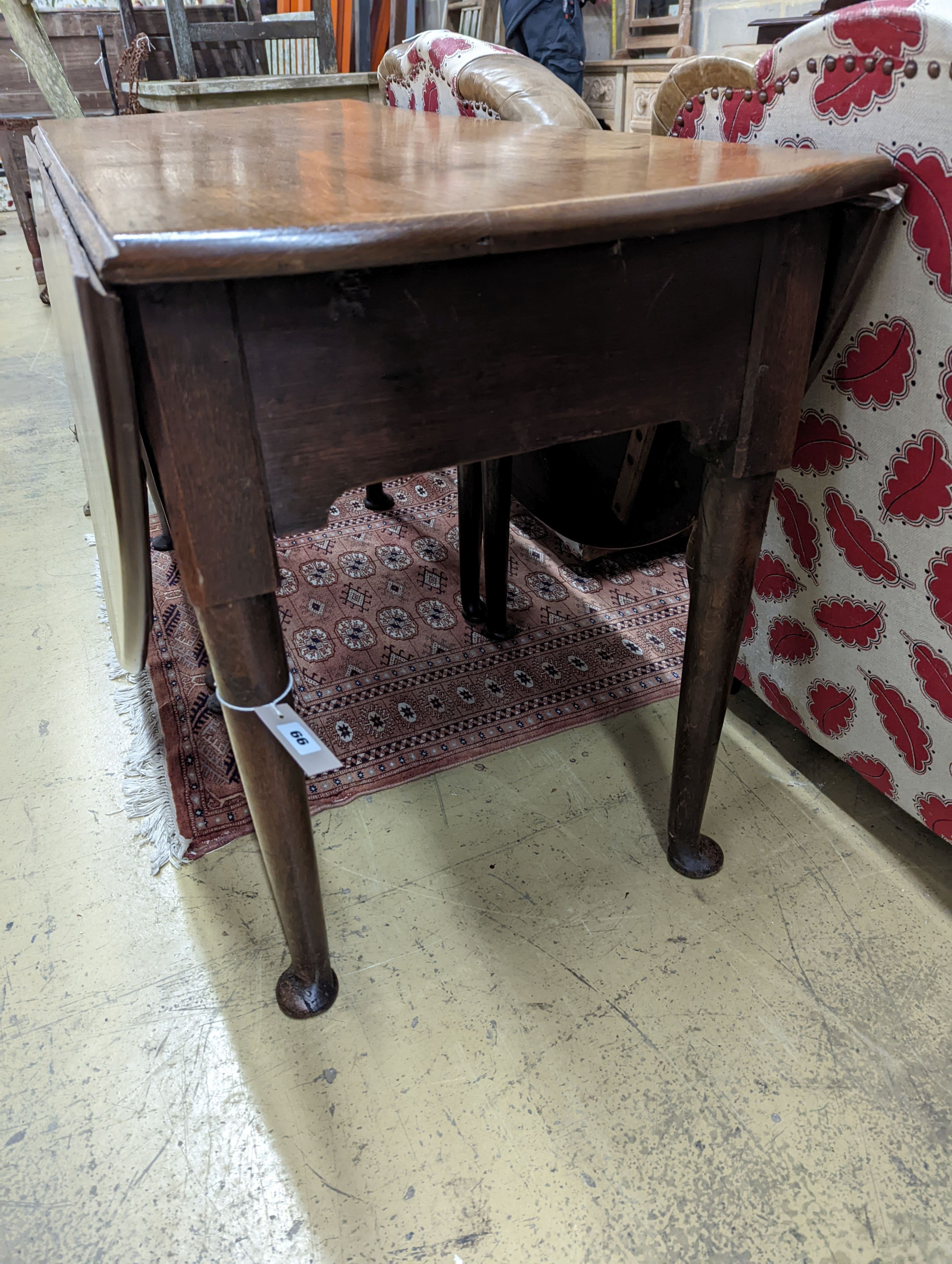 A mid 18th century oak gateleg table. W-132cm, D-156cm, H-71cm.